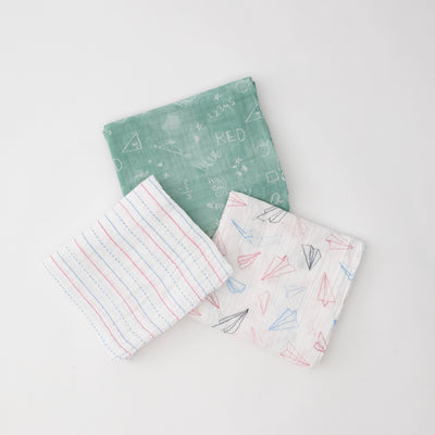 3 swaddle blankets featuring red and blue paper planes, lined paper print, and chalk board style print