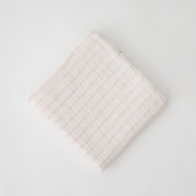 single swaddle blanket with pink crossed stripes on a white background