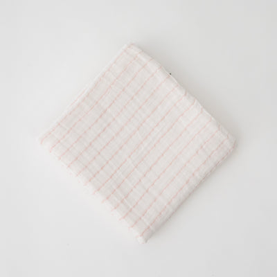 single swaddle blanket with pink crossed stripes on a white background