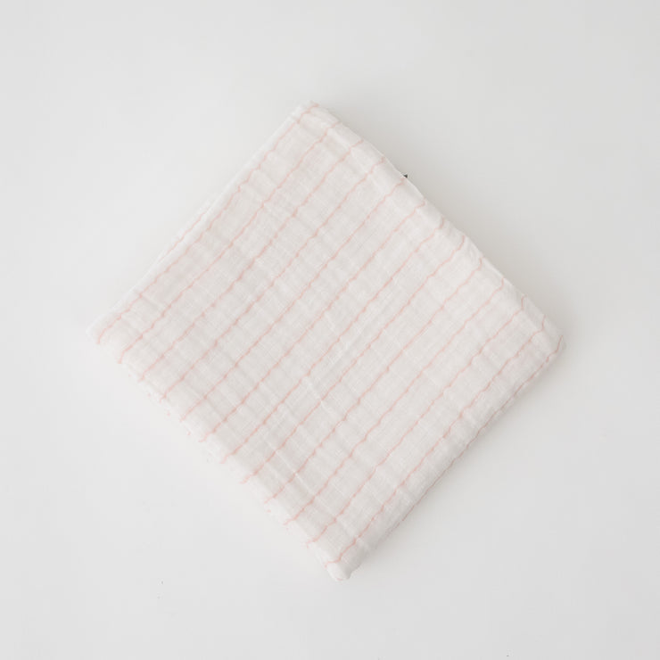 single swaddle blanket with pink crossed stripes on a white background