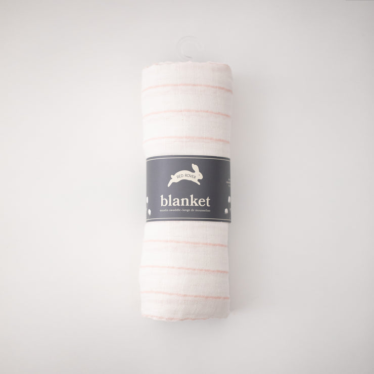 single swaddle blanket with pink crossed stripes on a white background rolled in Red Rover packaging