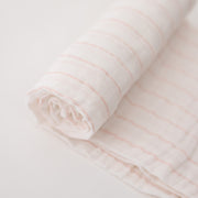 single swaddle blanket with pink crossed stripes on a white background
