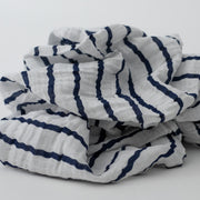 single swaddle blanket with navy stripes on a white background