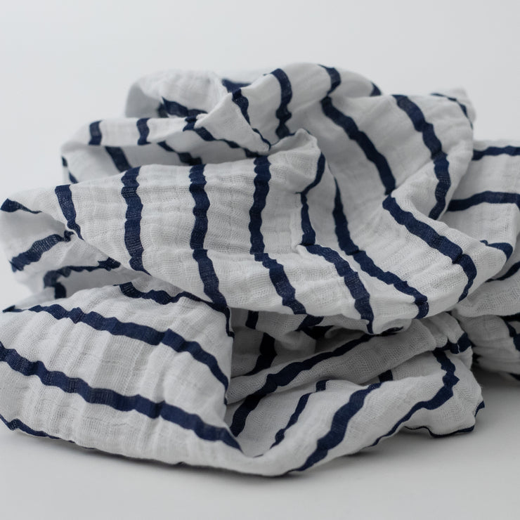 single swaddle blanket with navy stripes on a white background