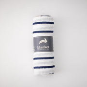 single swaddle blanket with navy stripes on a white background rolled in Red Rover packaging
