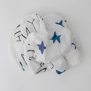 single swaddle blanket with with blue stars, and yellow sun, and the words "you are my sun my moon and all my stars" all on a white background