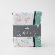 super soft cotton muslin quilt with paper airplanes on one side and a chalk board style print on the other side