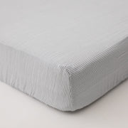cotton muslin crib sheet with very small grey stripes