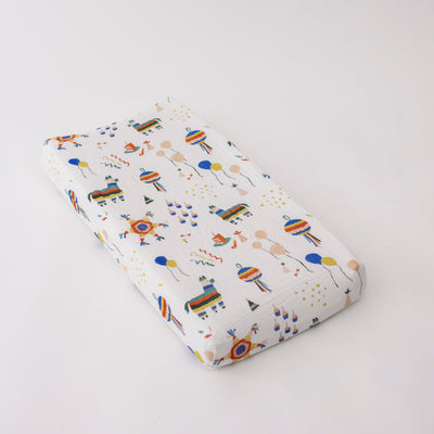 cotton muslin changing pad cover with party them print including pinatas, confetti, cake, balloons, party hats and more
